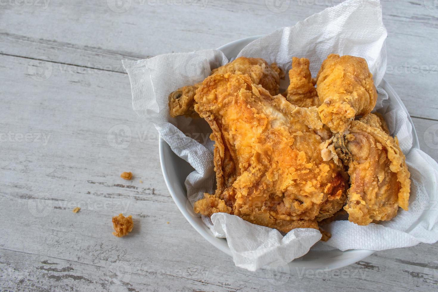 Fried chicken pieces in a bowl with copy space photo