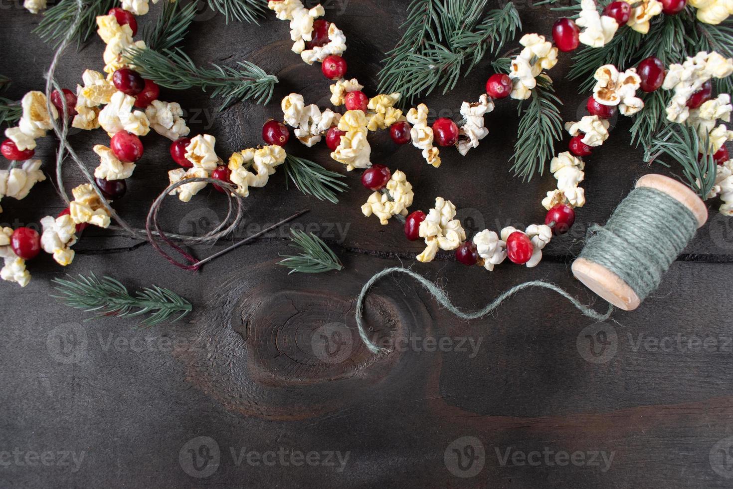 Christmas garland of red cranberries and popcorn kernels with copy space photo