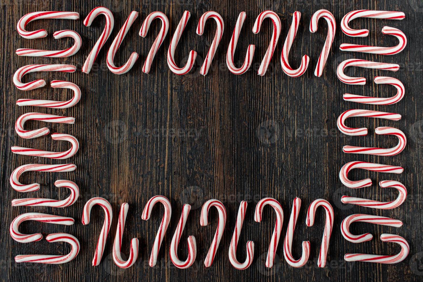 alternating direction candy cane border with copy space on rustic wood table flat lay photo