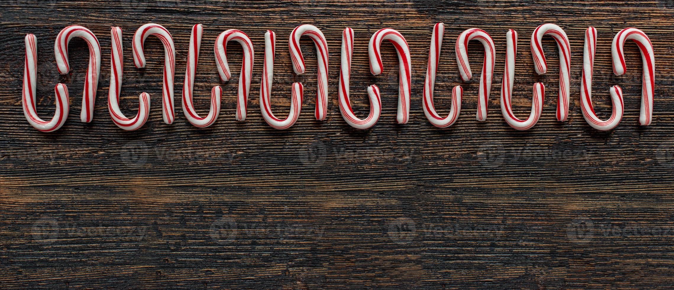 alternating direction candy cane border with copy space on rustic wood table flat lay photo