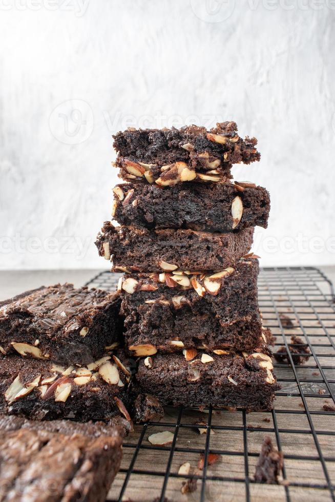 stack of sliced homemade brownie squares with almonds photo