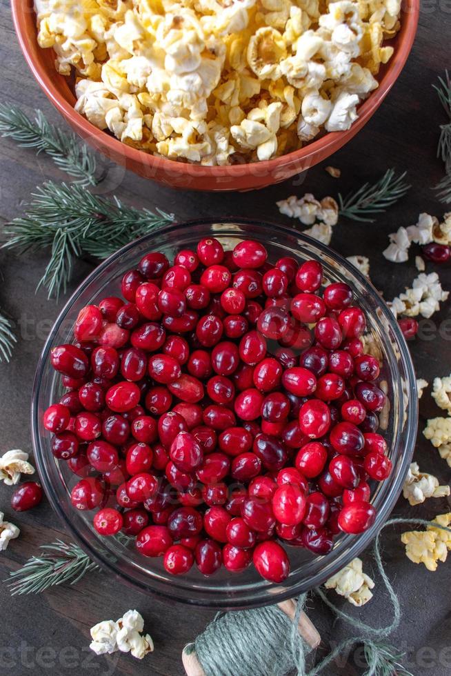 bowls of cranberries and popcorn for stringing Christmas garland top view photo