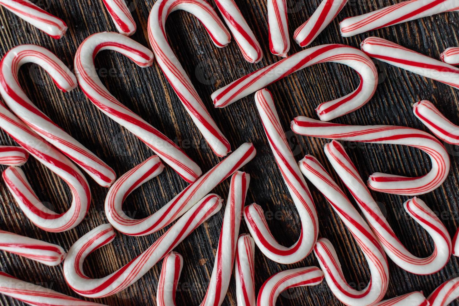 design group of candy canes on rustic wood table flat lay photo
