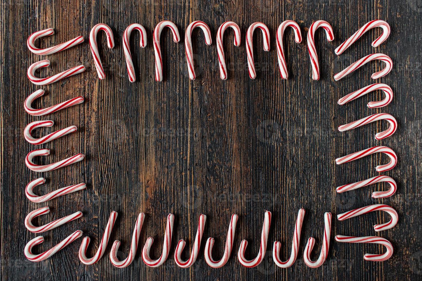 candy cane border with copy space on rustic wood table flat lay photo