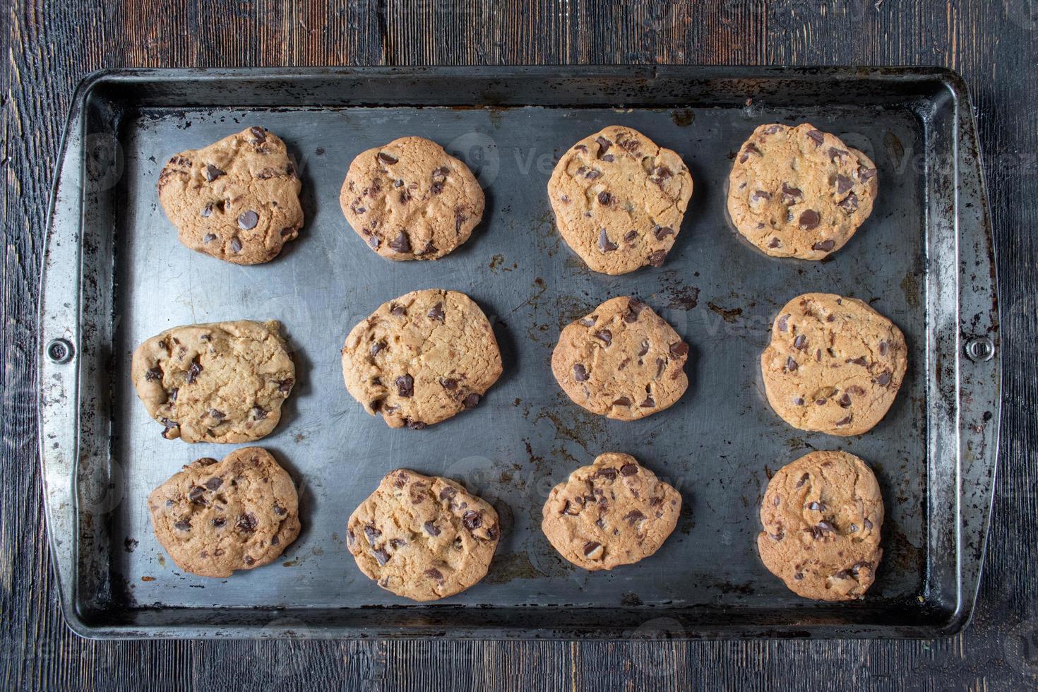 flat lay metal baking tray of baked chocolate chip cookies photo