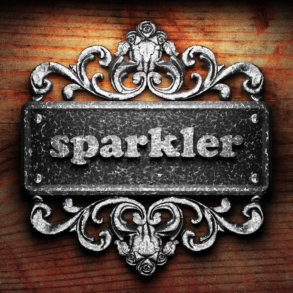 sparkler word of iron on wooden background photo