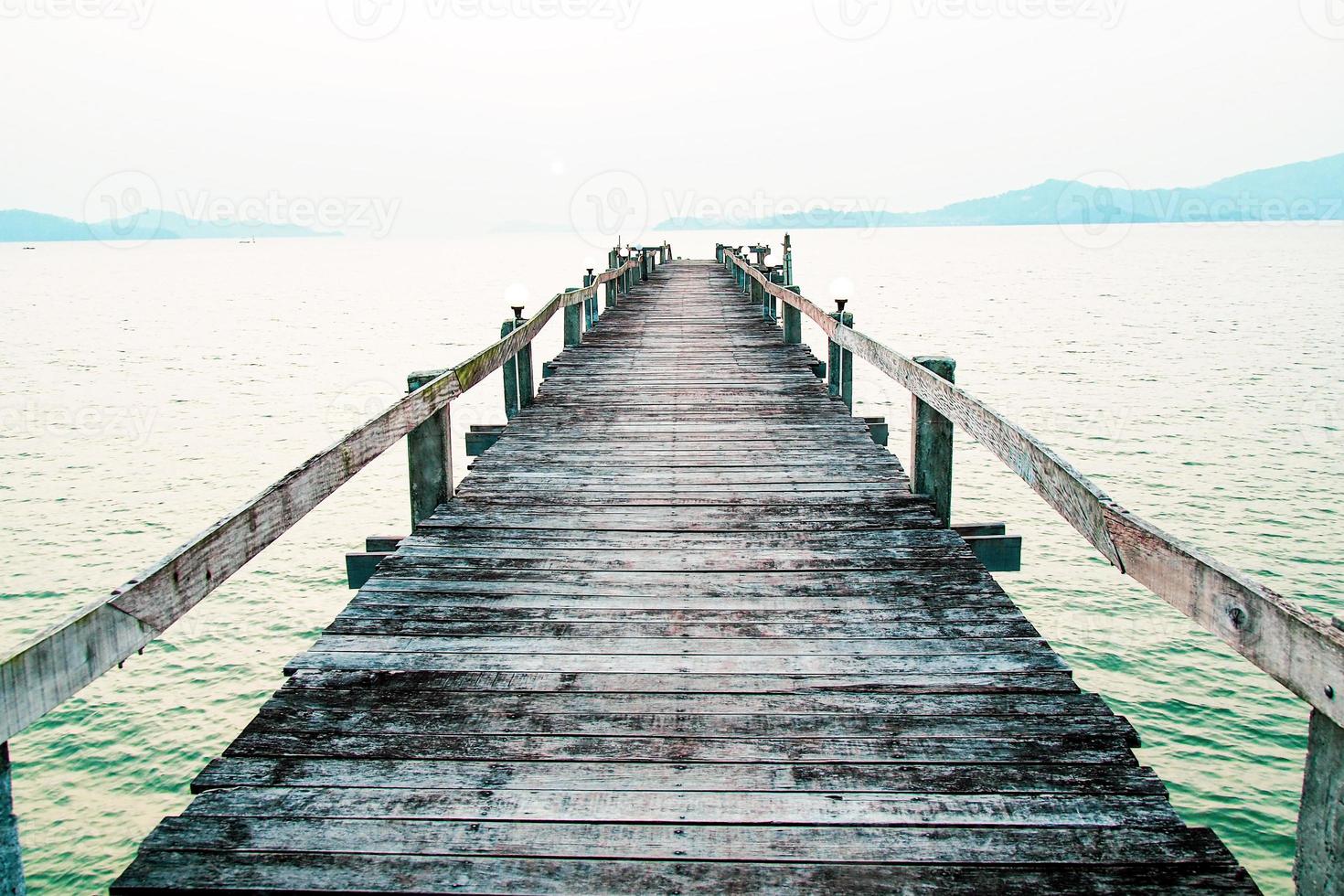 A wooden walkway that stretches into the sea. vacation travel concept photo