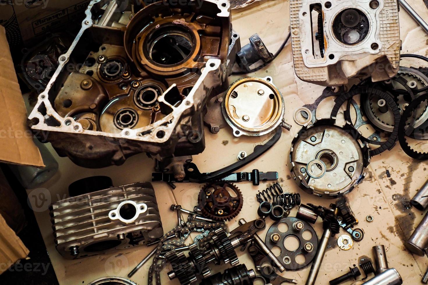 Parts of a motorcycle engine removed for maintenance. engine maintenance concept photo