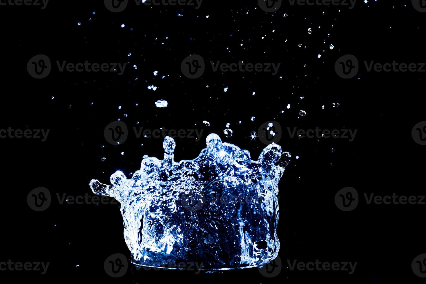 Scattered water splashes on a black background. water splash isolated on the black background photo