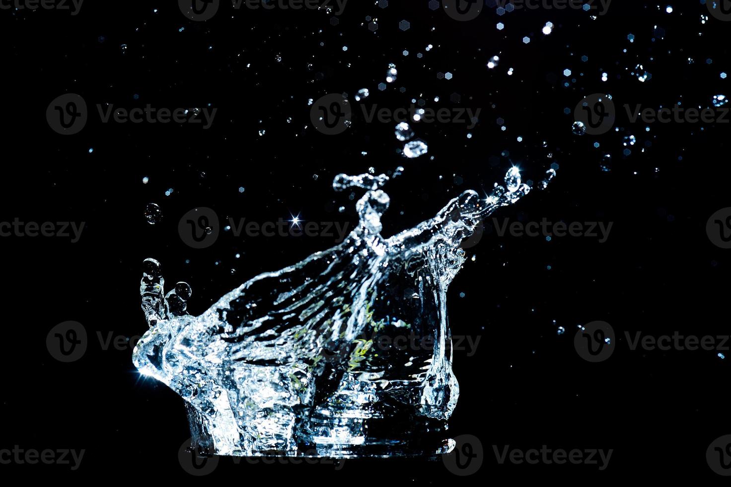 Scattered water splashes on a black background. water splash isolated on the black background photo