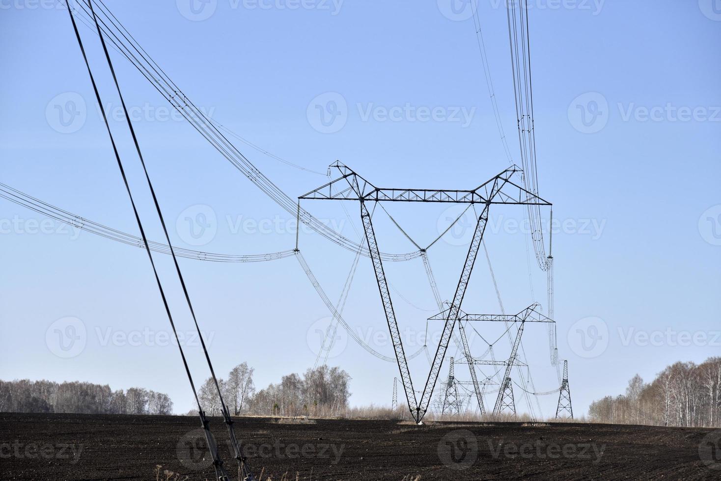 Ultra-high voltage power line in the field in spring in Russia photo