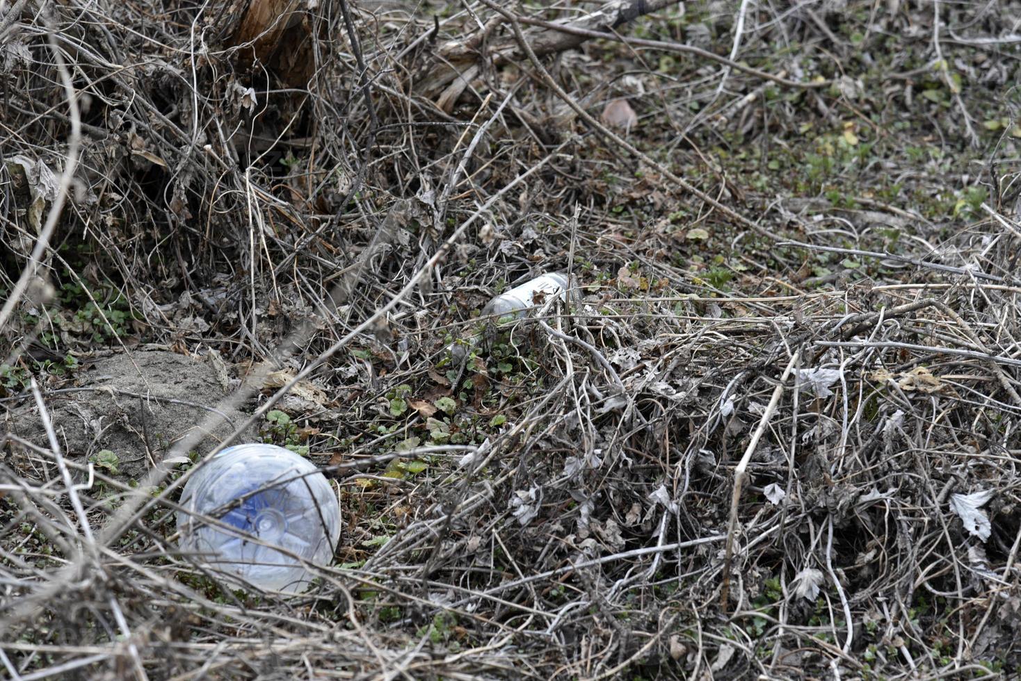 Garbage and household waste on the riverbank from vacationers. Environmental pollution. photo