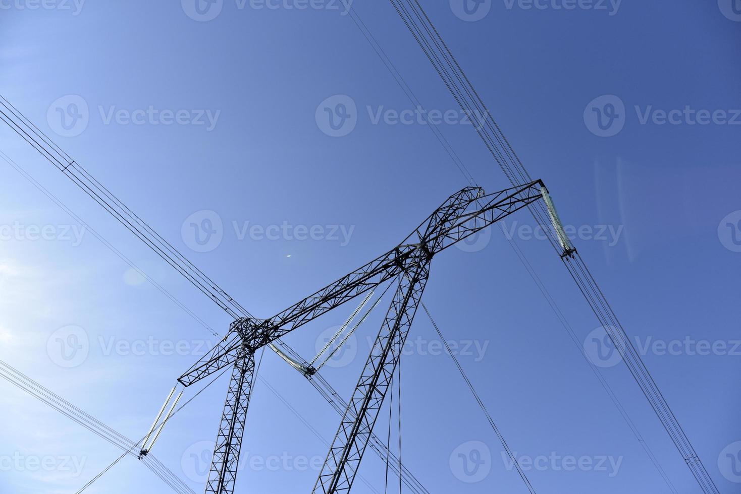 Ultra-high voltage power line in the field in spring in Russia photo