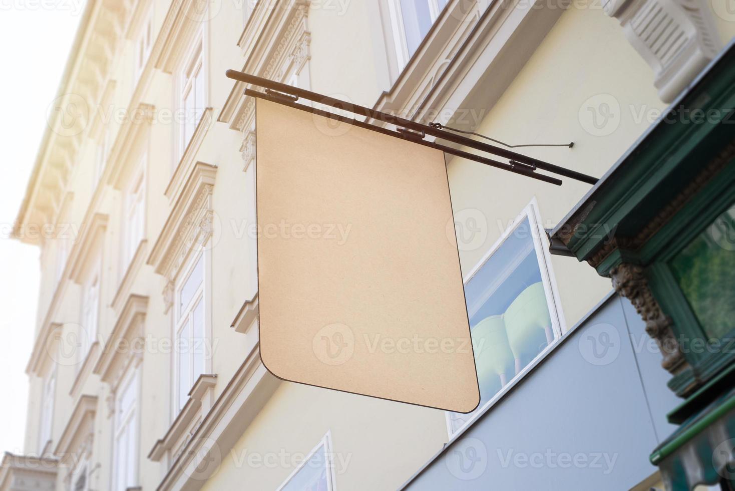 Blank square vintage signage for cafe, restaurant, shop name and logo presentation. In the center of the old town. City building in background photo