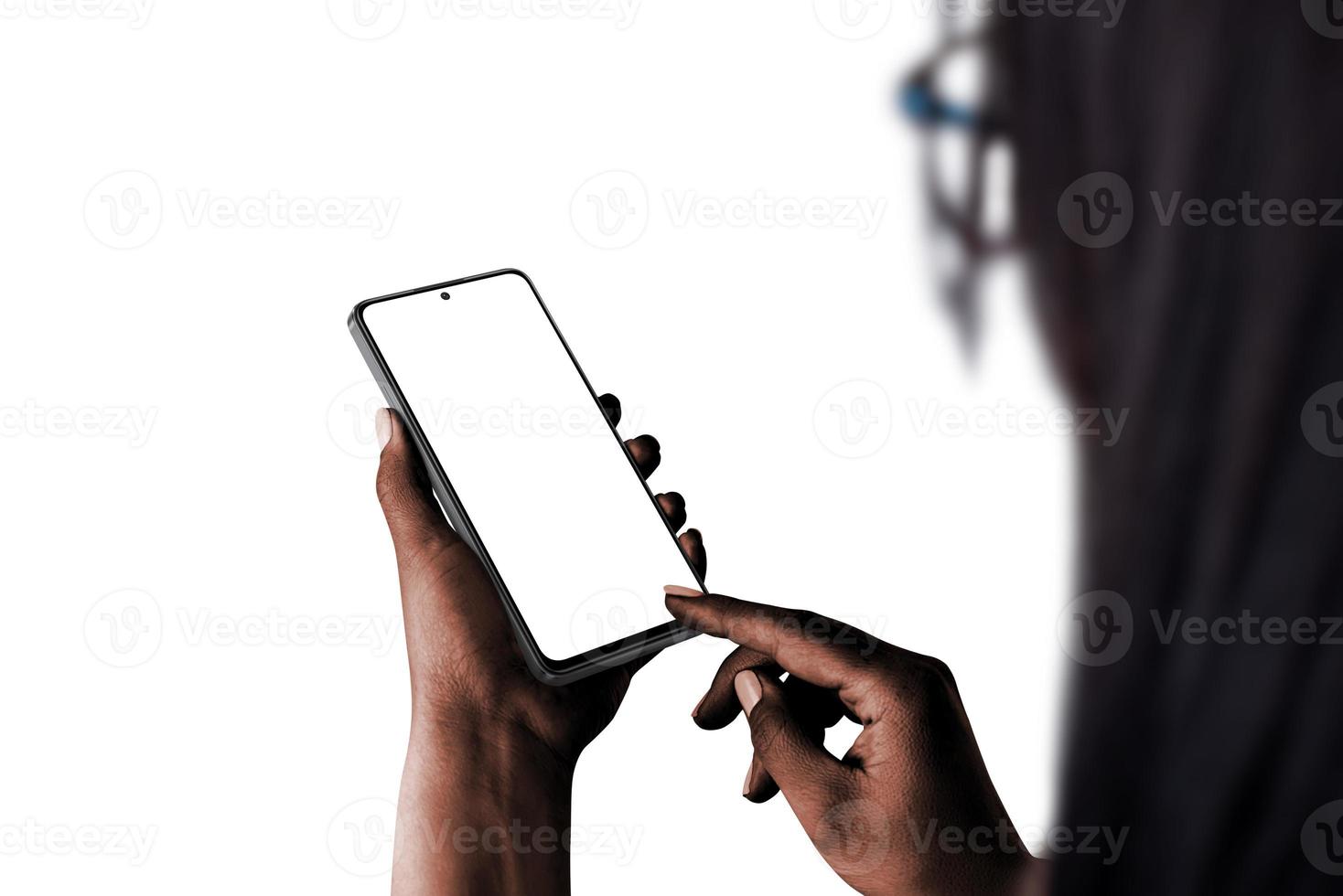 Phone mockup in woman hand, dark skin, low light isolated. Over shoulder view photo