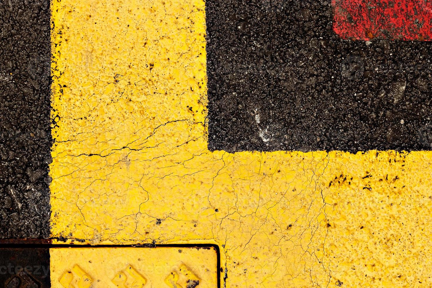 Asphalt painted yellow and red, suitable for textured abstract background. photo
