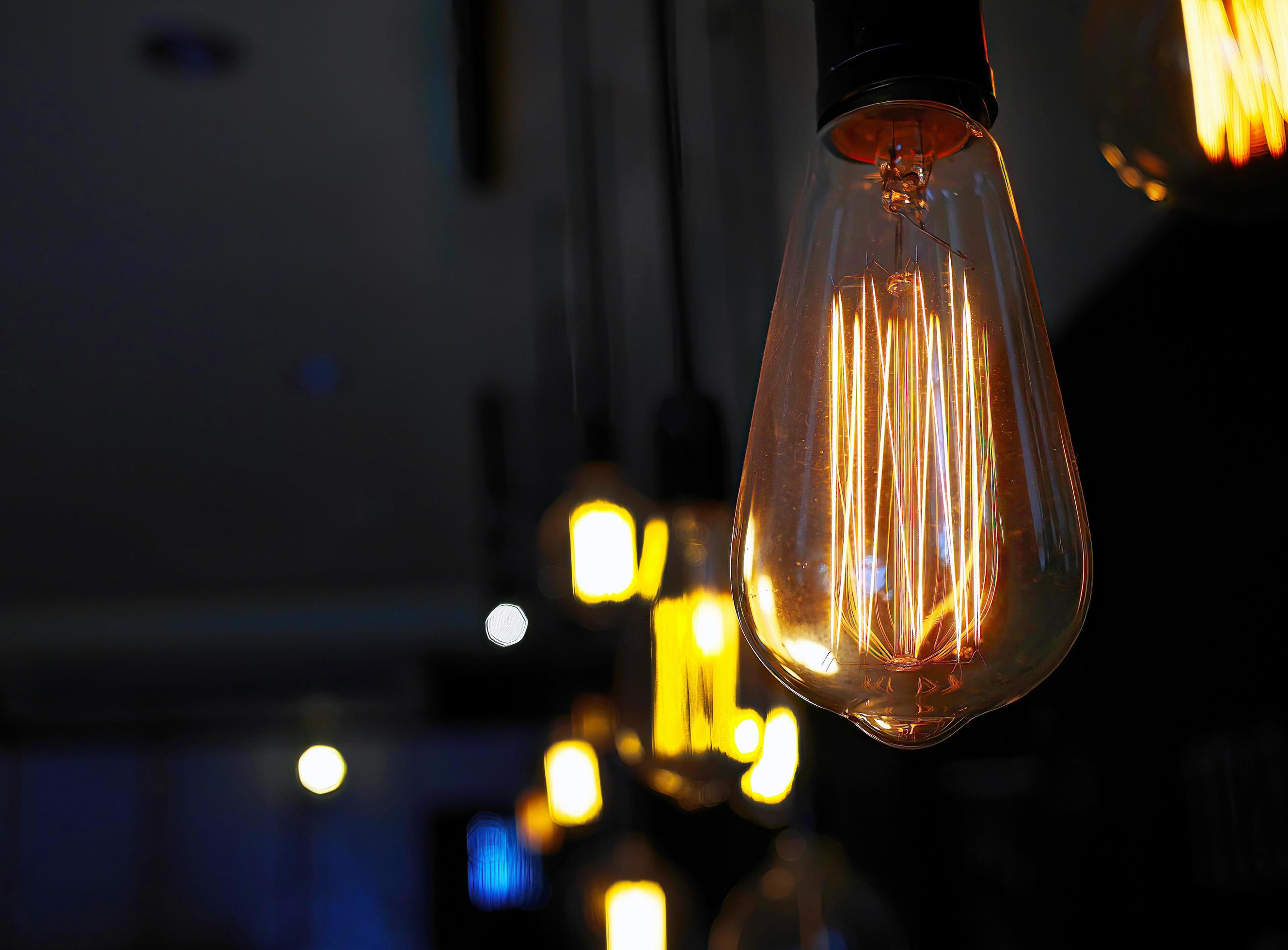 Vintage style light bulbs hanging on ceiling. Decorative lights