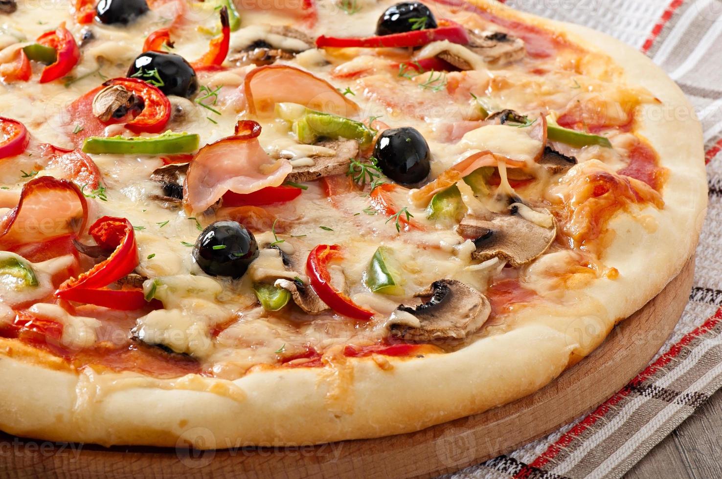 Pizza with ham, mushrooms and olives photo