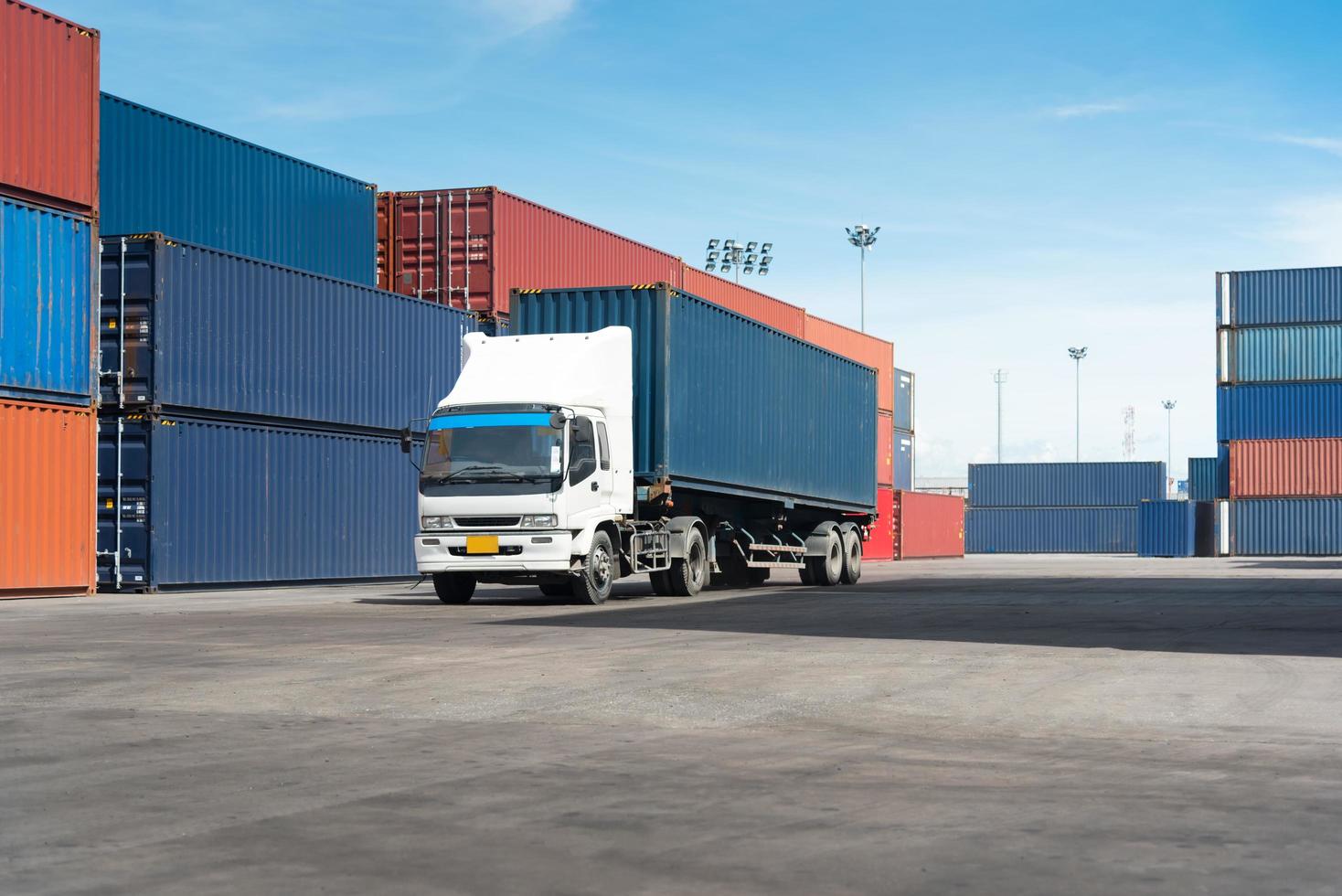 truck with cargo container on road in shipping yard photo