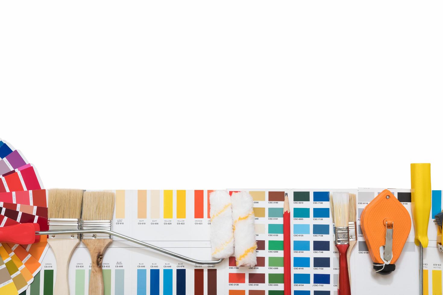 Professional decorator drawing on a house project with work tools photo