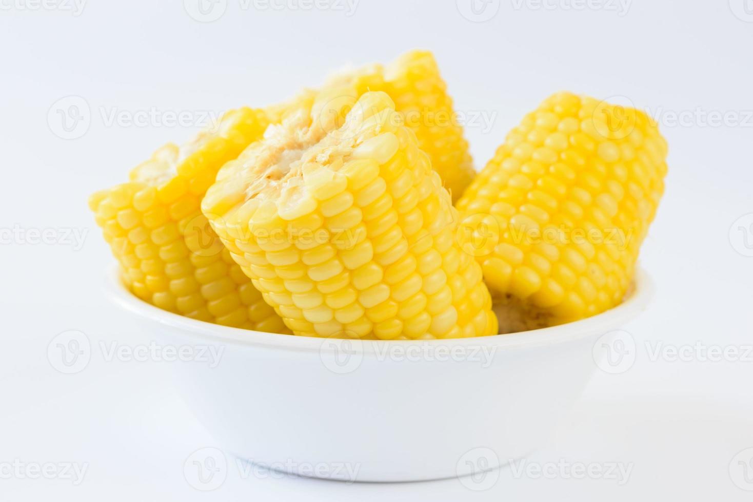 Pieces of boil corns in white bowl photo