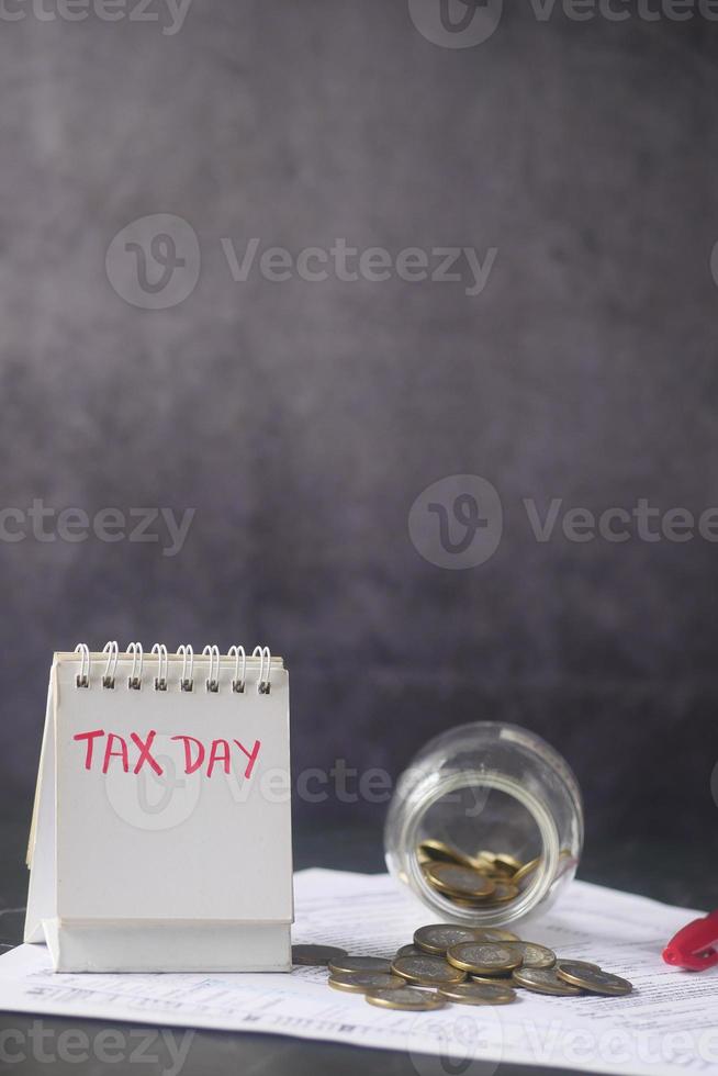 Tax return form and hand written tax date on a calendar table photo