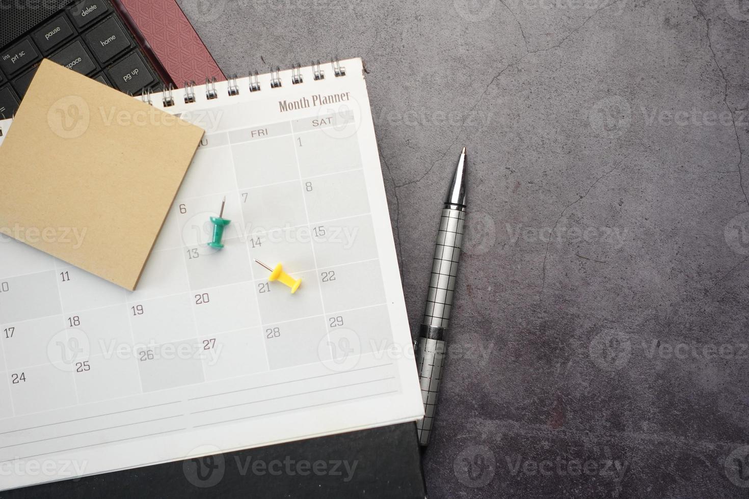 flat composition of calendar and laptop on black background photo