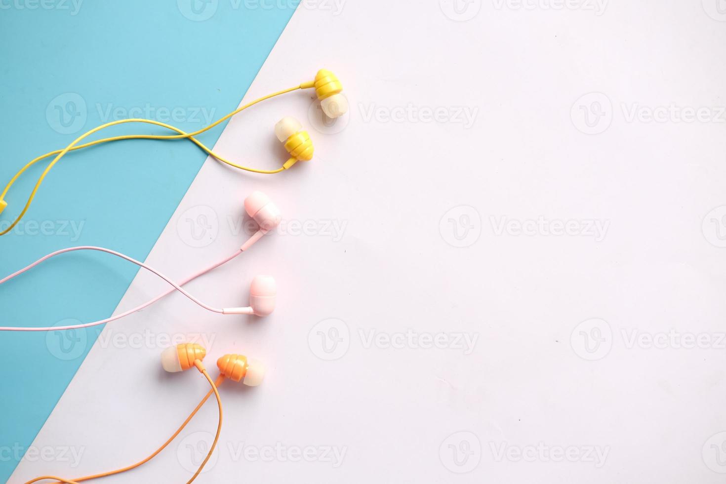 top view of colorful earphone on color background photo