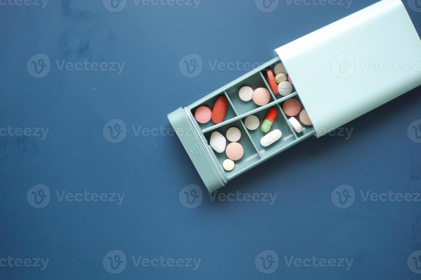 close up of medical pills in a pill box on table photo