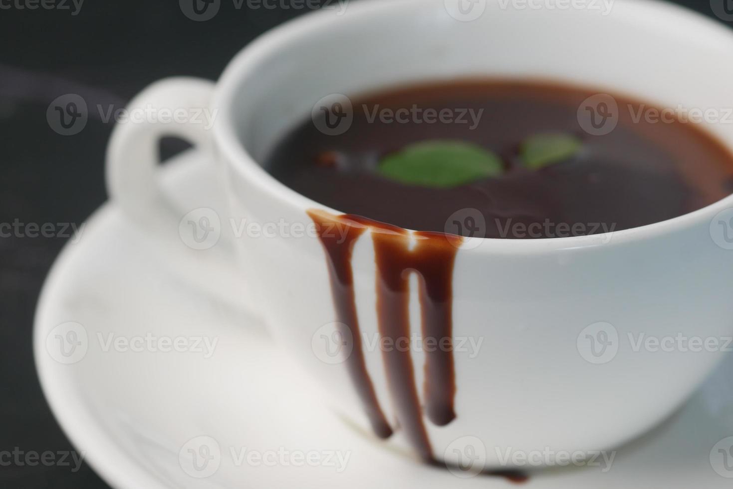 dark chocolate cream in a coffee cup on table photo
