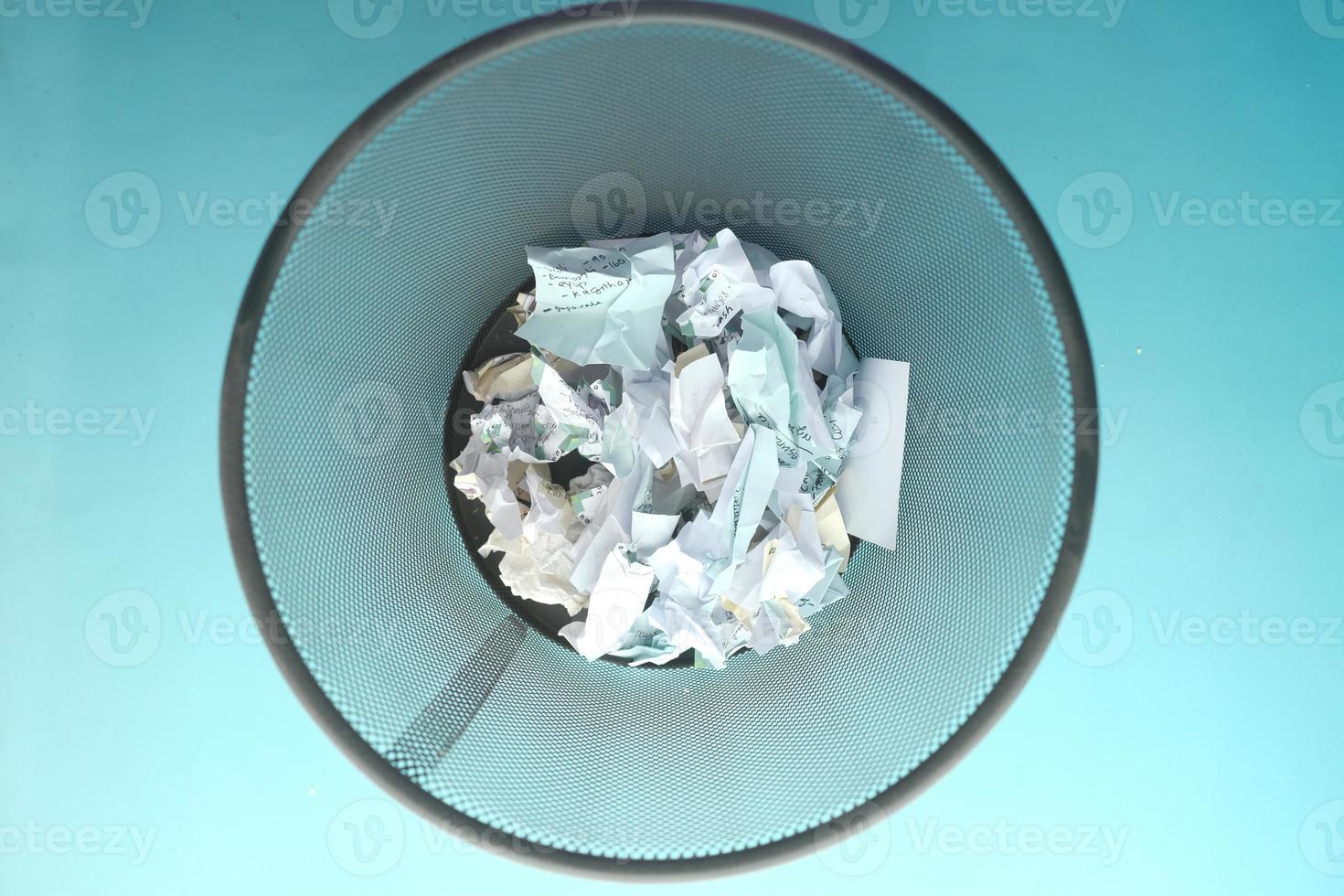 crumpled paper ball in a bin top view photo