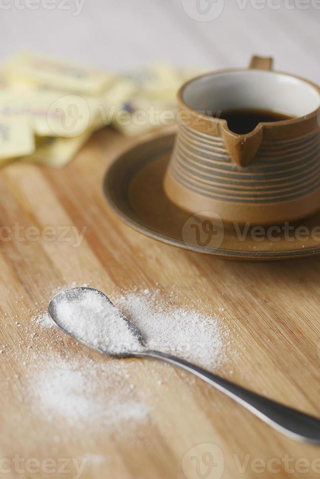 Sugar Substitute sweetener and tea cup on table photo