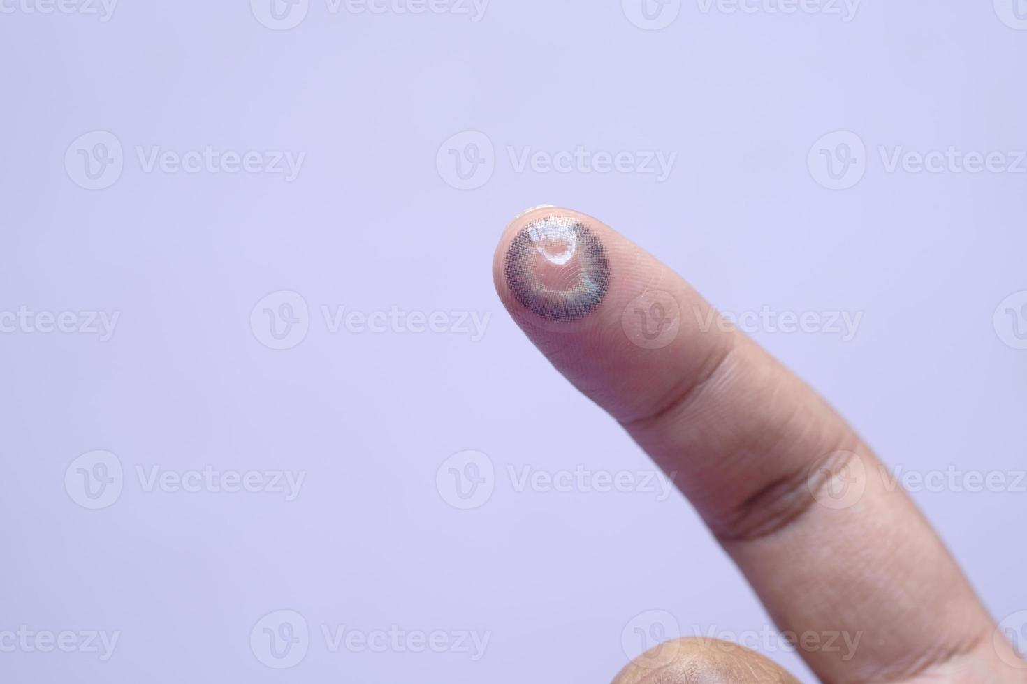 close up of Contact lens on a finger . photo