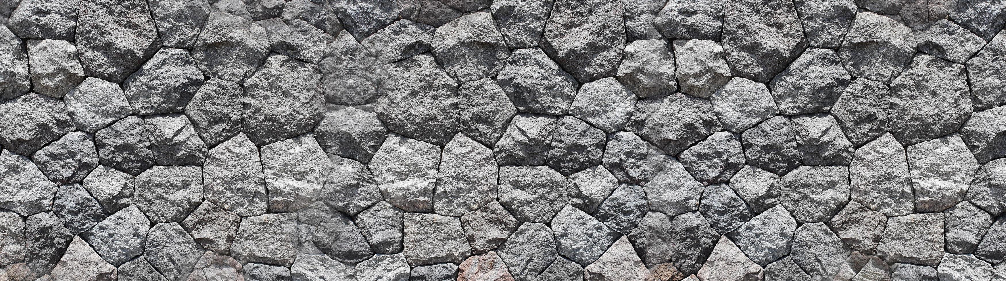 Panoramic Pebbles stone for background. Old brick wall from a stone. photo