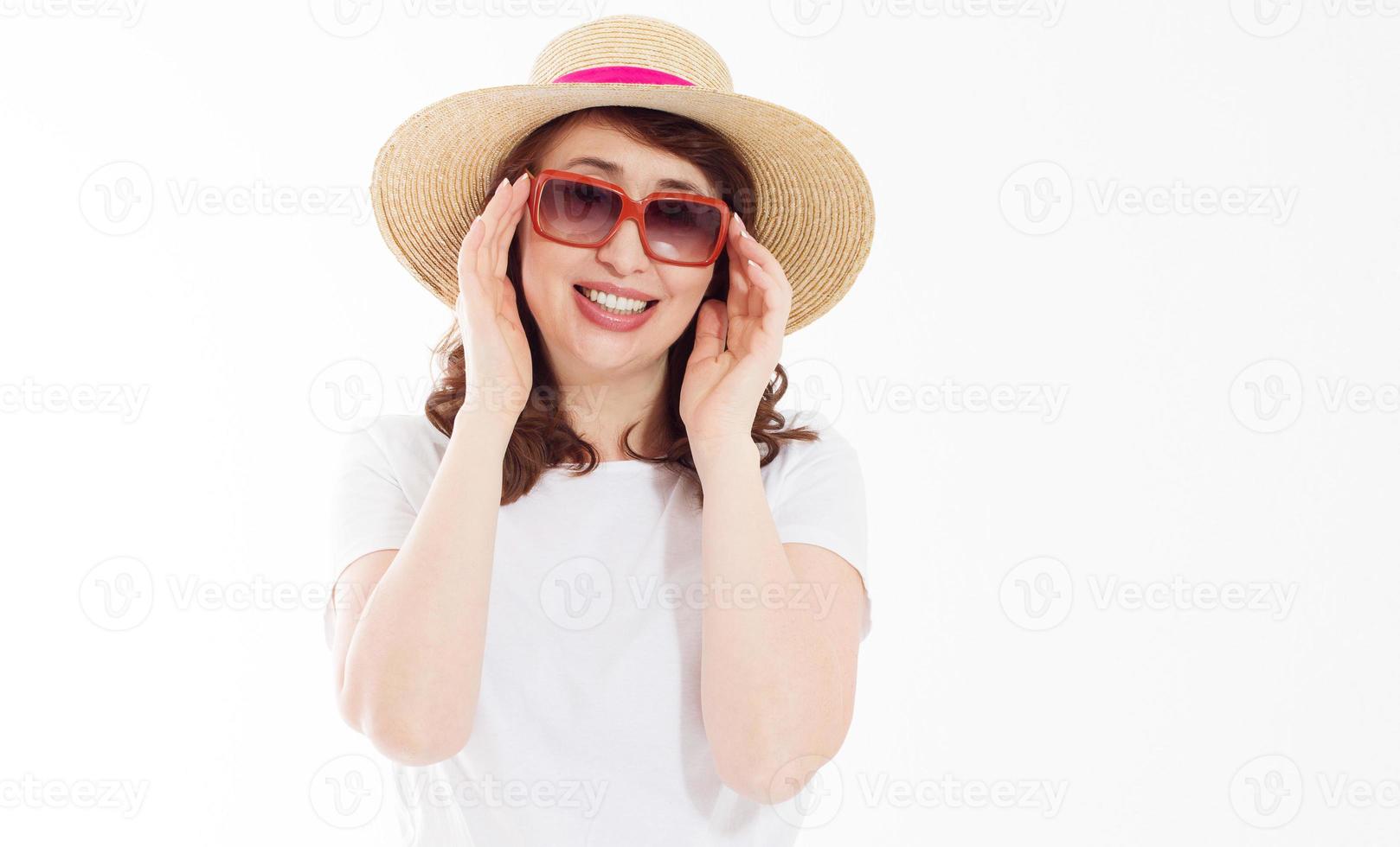 Middle age happy woman in summer hat, sunglasses. Summertime skin protection, fashion accessories. Female in blank template white t shirt isolated. Copy space background. Holiday and beach vacation. photo