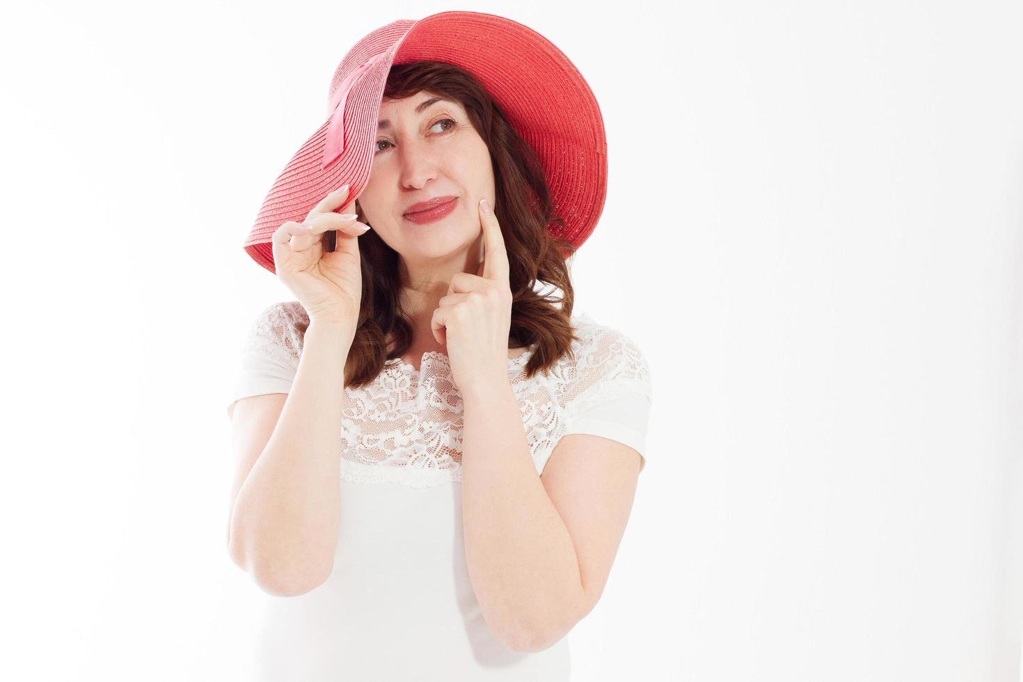 Happy woman in summer hat isolated on white background. Sun protection skin care and vacation holidays concept. Middle age female with white healthy teeth and menopause. Travel vacation. Copy space photo