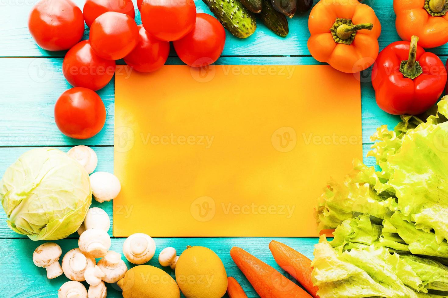 Different vegetables on kitchen table with recipe list and copy space. Top view photo