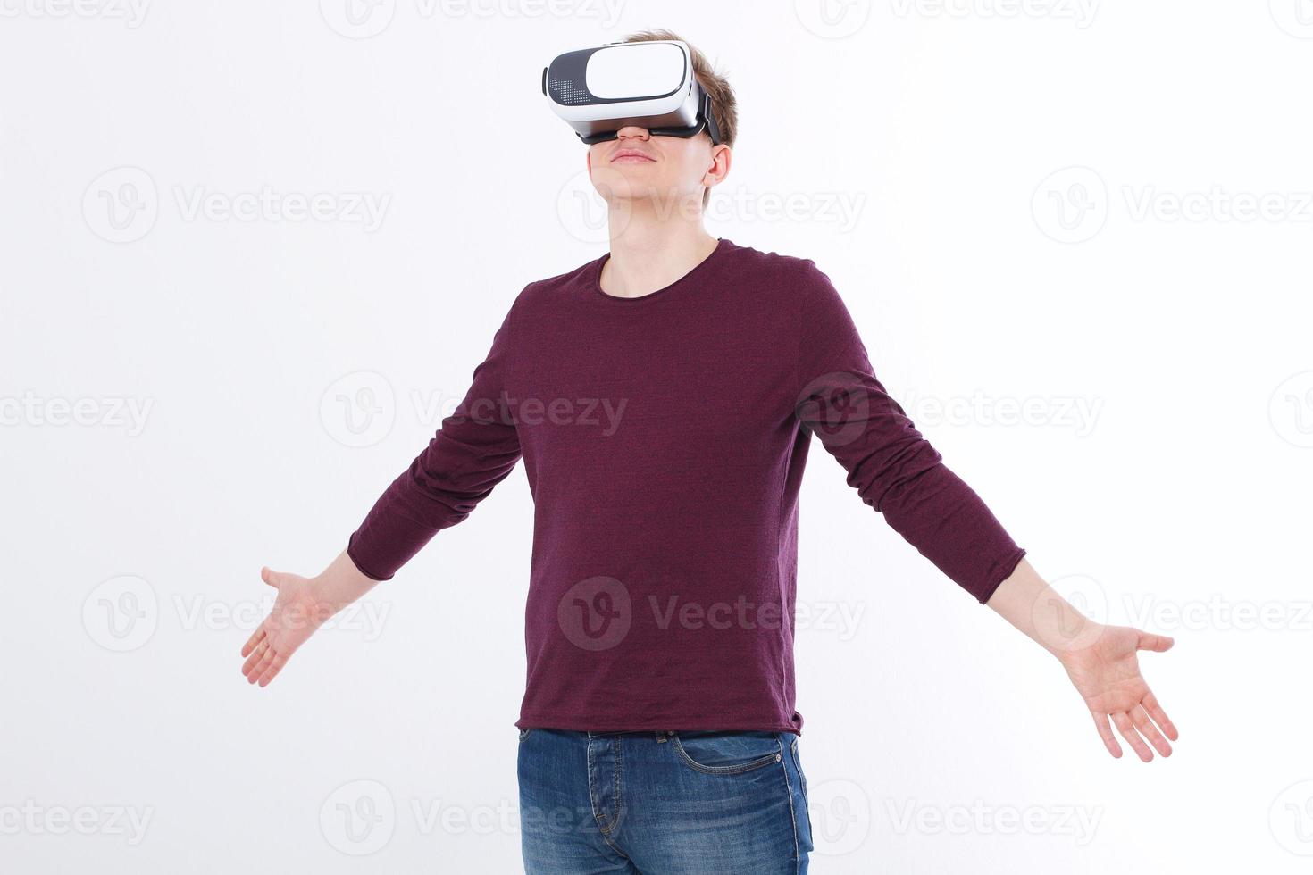 Young man wearing virtual reality goggles isolated on white background. Digital VR glasses for 360 game. Template and blank shirt. Copy space and mock up photo