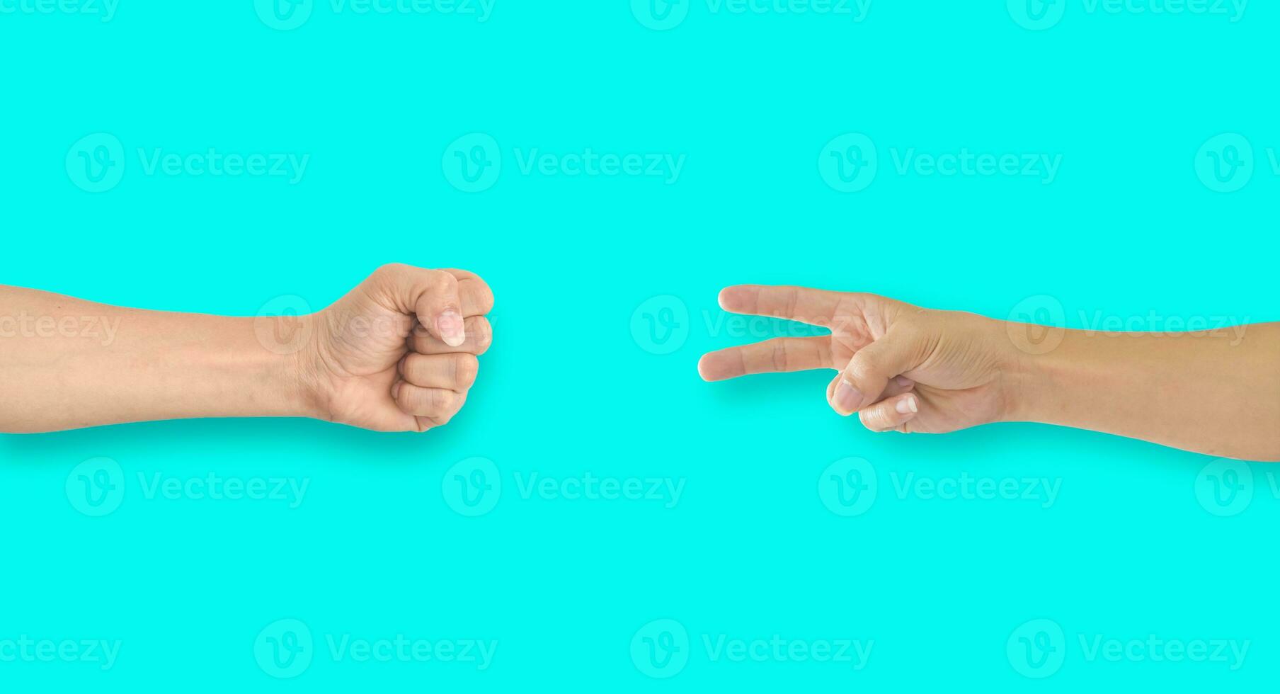 Two hands playing rock-paper-scissors on blue background photo