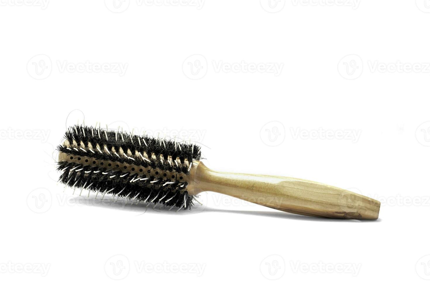 Round hairbrush with wooden handle isolated on white background. photo