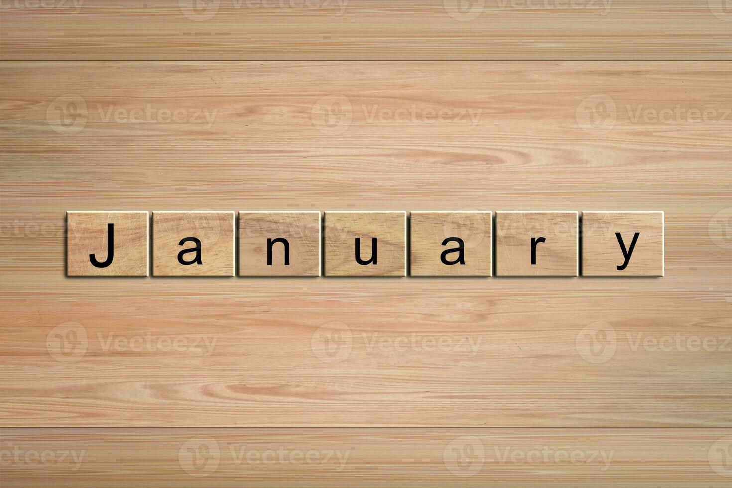 January word written on wood block. Message text on wooden table for backdrop design. photo