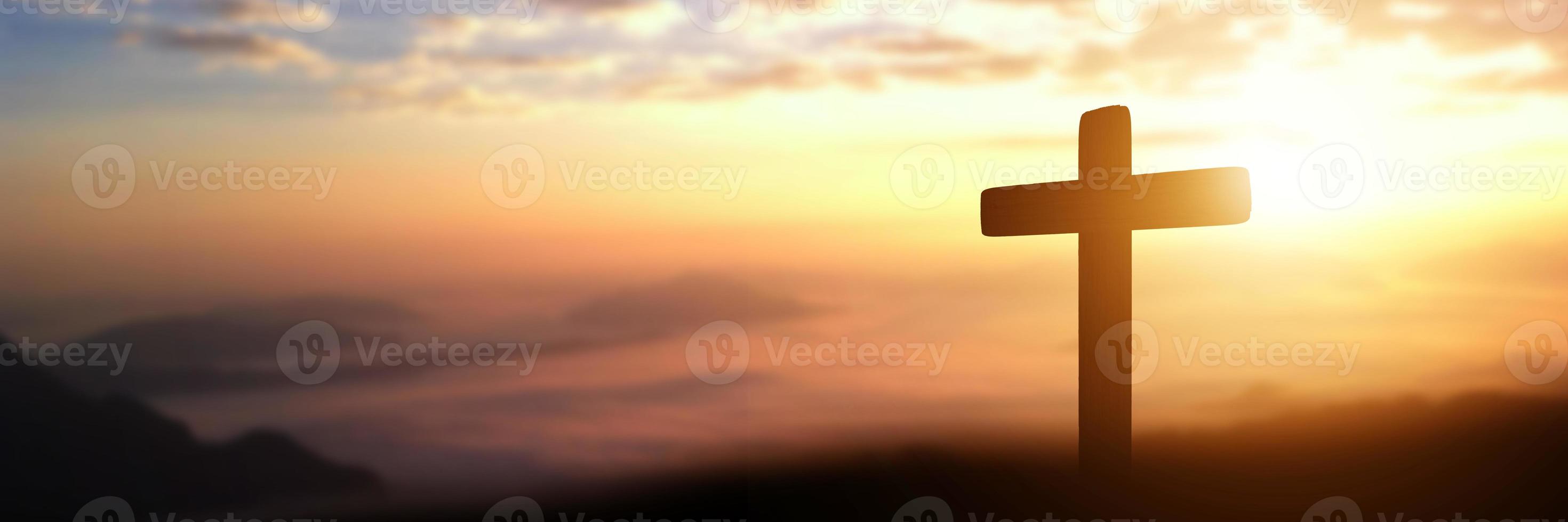 Silhouette of catholic cross at sunset background. panorama picture photo