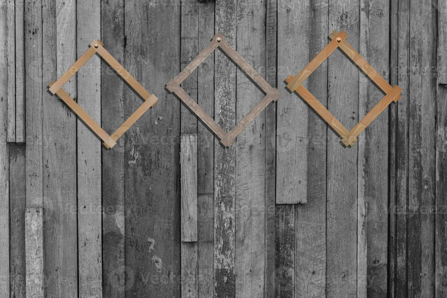 Vintage photo frames on wood wall for interior or background.