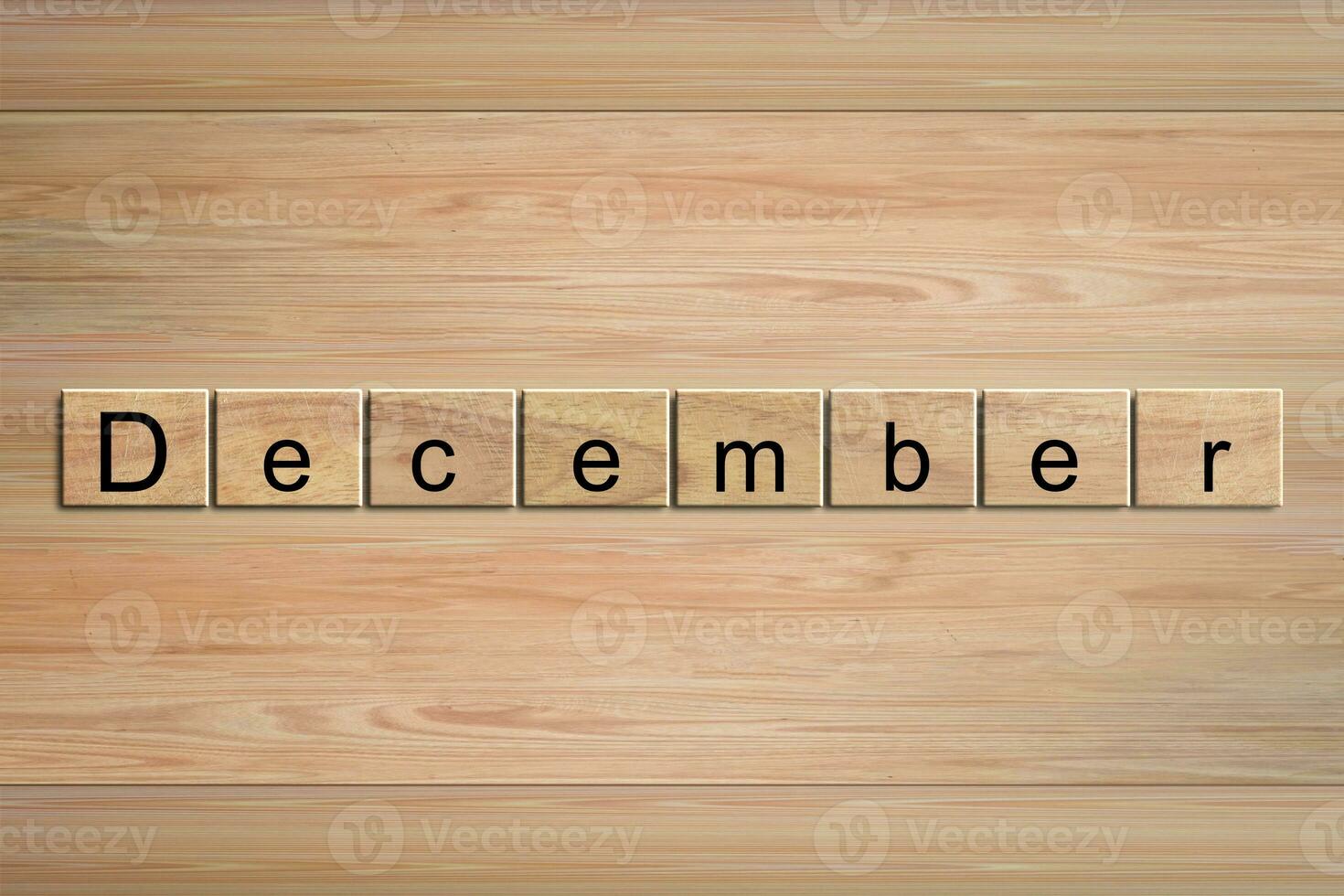 December word written on wood block. Message text on wooden table for backdrop design. photo