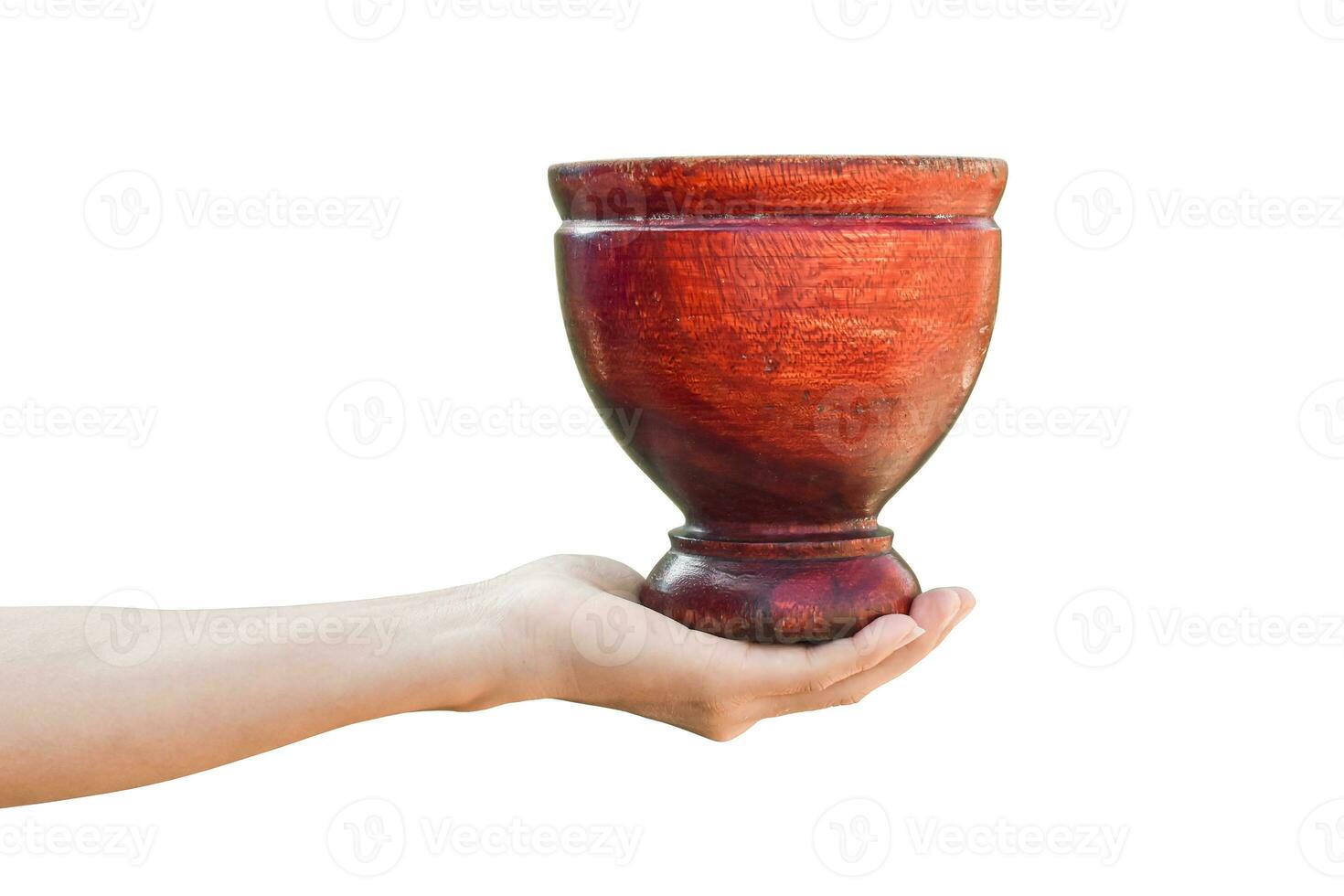 hand holding wooden mortar isolated on white background with clipping path. photo
