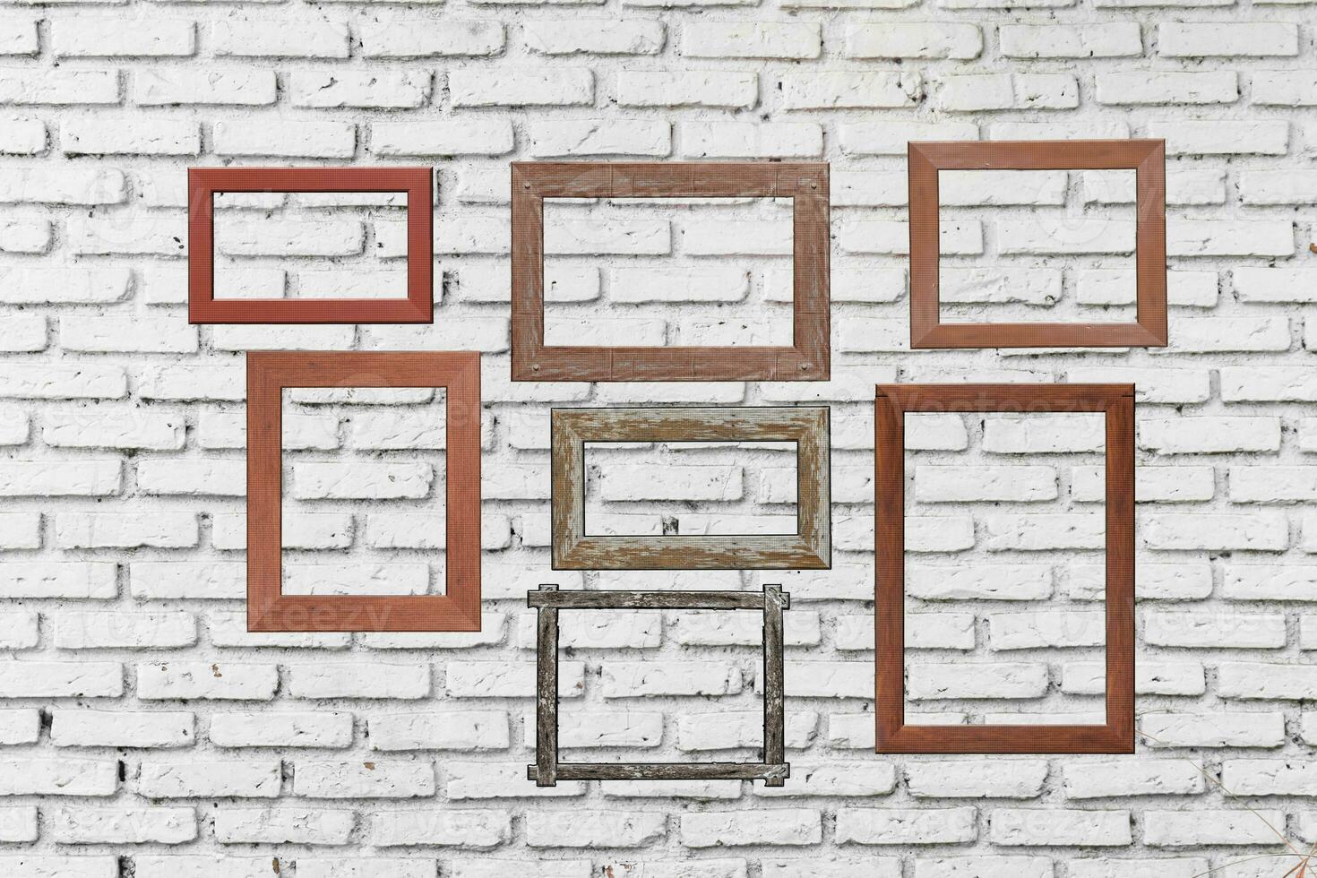 old photo wood frames on white brick wall. Wooden picture frame.