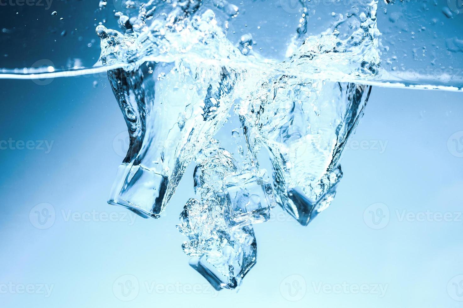 Abstract background image of ice cubes in blue water. photo