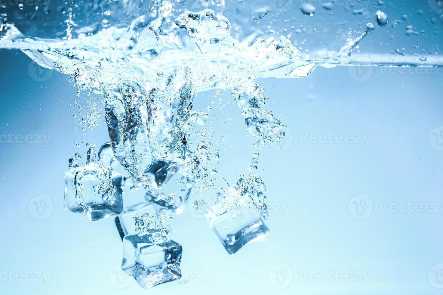 Abstract background image of ice cubes in blue water. photo