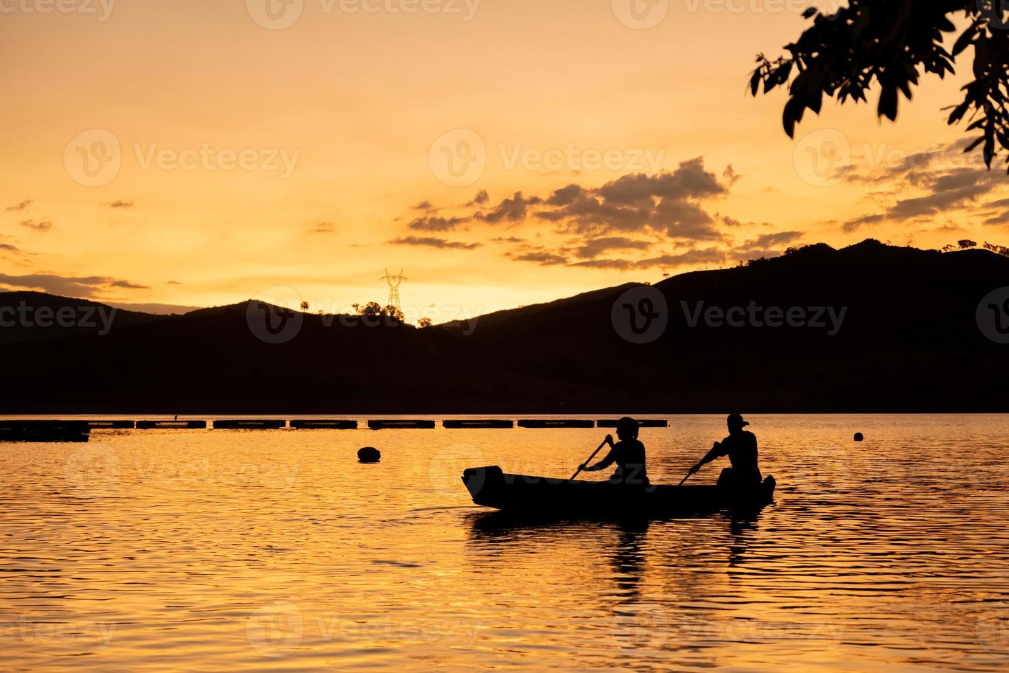 Two people rowing at sunset photo