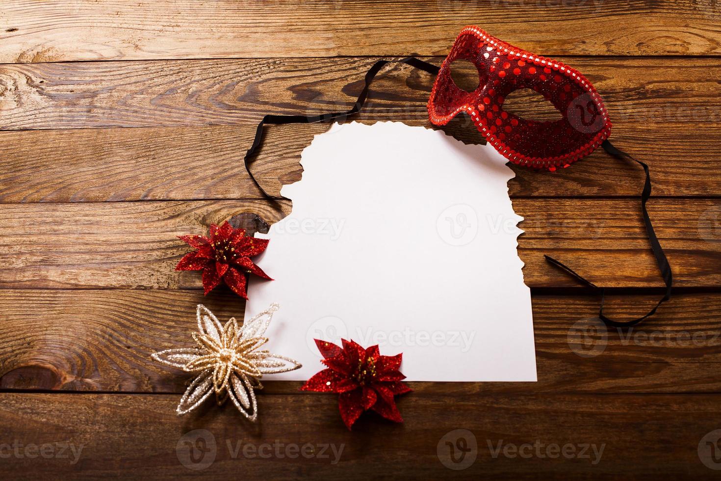 Christmas card and New Year accessories on brown wooden table. Top view. Copy space and place for text. photo
